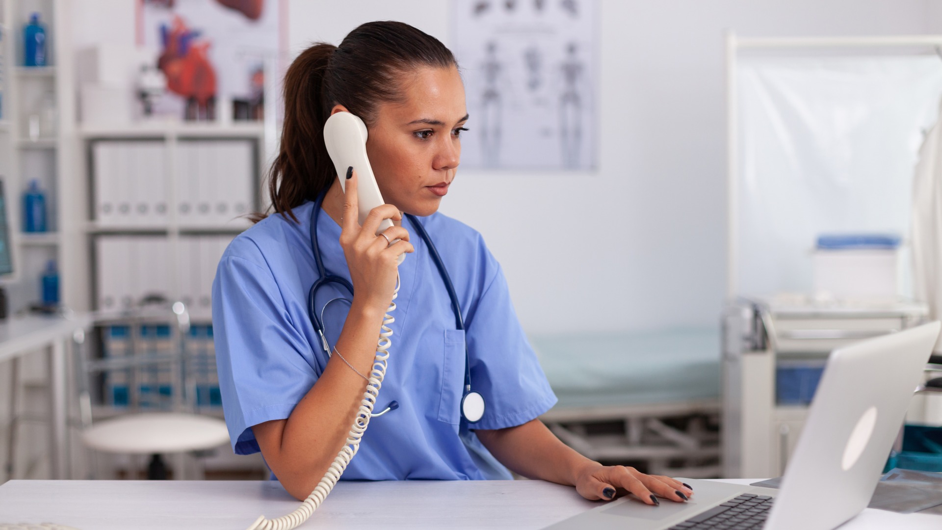Medical receptionist handling clinic phone calls